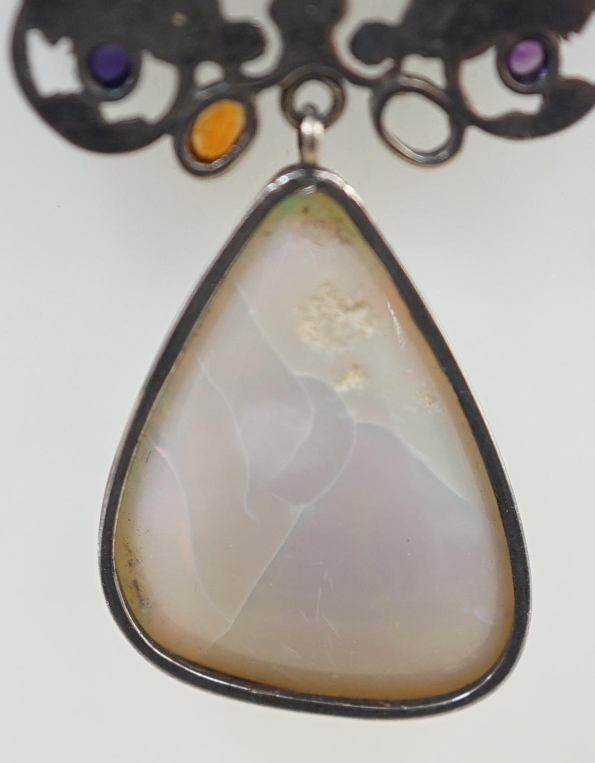 An early 20th century silver, white opal and cabochon gem cluster set drop pendant necklace, in the manner of Sibyl Dunlop